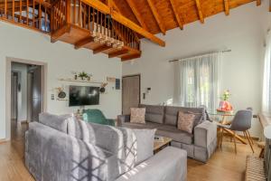 a living room with a couch and a table at Private Pool Retreat - Georgia's Garden Oasis in Alónia