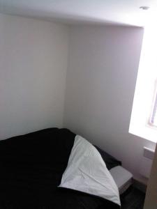 - une chambre avec un lit noir et blanc et une fenêtre dans l'établissement Le Panorachic, à Satillieu