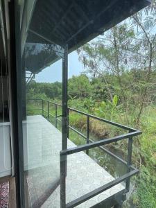 a view of a walkway from a glass door at Casa Khang - a peaceful cottage close to HCMC in Xã Cam Mỹ