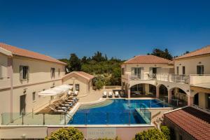 an image of a swimming pool in a building at Belle View Hotel - Sea View & Sunset in Mánganos
