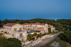 an aerial view of a house with a swimming pool at Belle View Hotel - Sea View & Sunset in Mánganos