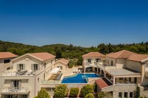an aerial view of a house with a swimming pool at Belle View Hotel - Sea View & Sunset in Mánganos