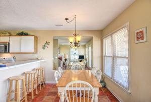 a kitchen and dining room with a table and chairs at Helmstetler #3B in Topsail Beach