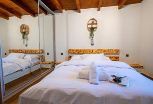 a bedroom with two beds with white sheets at Private Pool Retreat - Georgia's Garden Oasis in Alónia +22 photos