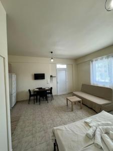 a living room with a couch and a table at Airpoint Apartments in Artemida