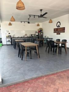 a room with tables and chairs and a kitchen at Villa The Quarry Segamat in Segamat