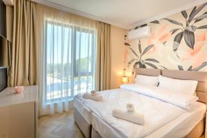 a bedroom with a large bed and a large window at Saint George apartments in Varna City +94 photos