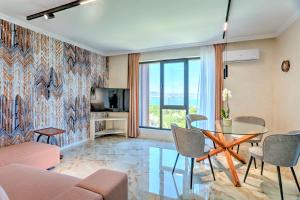 a living room with a glass table and chairs at Saint George apartments in Varna City