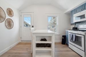 a kitchen with a white table and a stove at Newly Renovated Professional Design Partial Ocean Views in Hampton