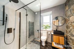 a bathroom with a glass shower and a toilet at Kirkton Family Farmhouse with Hot Tub, Alford, Aberdeenshire in Alford +92 photos