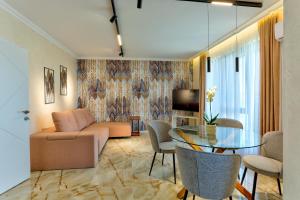 a living room with a couch and a table at Saint George apartments in Varna City