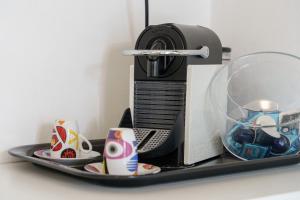 a tray with acomputer and cups on a table at monovano al duomo in Catania