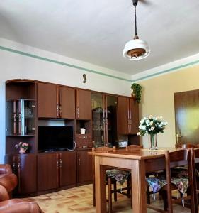 a kitchen with wooden cabinets and a wooden table at Relax nella Natura, Casa Vacanze con Vista in Toscana in Sestino
