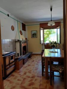a kitchen with a table and a dining room at Dalla Nonna Ida, Casa Vacanze con Vista in Toscana in Sestino +15 photos
