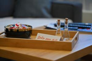 a tray with two glass bottles and a bowl on a table at Studio apartment 306 in Jahorina