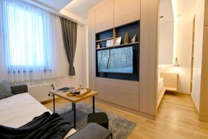 a living room with a tv and a table at Studio apartment 306 in Jahorina