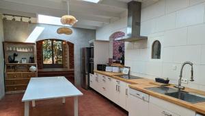 a large kitchen with a sink and a counter at Loft entre vignes et truffes - Gite en Provence Vaucluse in Valréas