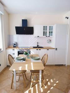 a kitchen with a wooden table and chairs at La Casina in Sassari