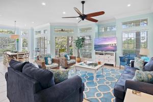 a living room with two couches and a flat screen tv at Tivoli 5292 in Destin