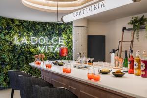 a bar with drinks on a counter with chairs at Barceló Tenerife in San Miguel de Abona