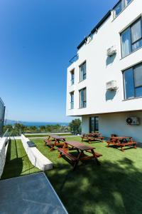 a group of picnic tables in front of a building at Saint George apartments in Varna City