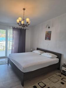a bedroom with a large bed with a chandelier at Villa Merica in Trogir +74 photos