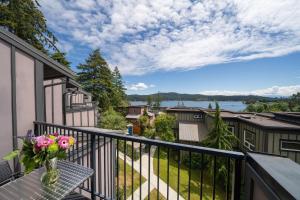 a balcony with a table and a vase of flowers at Sooke Harbour Resort & Marina in Sooke