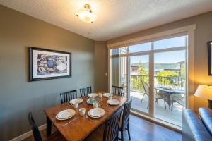 a dining room with a table with chairs and a large window at Sooke Harbour Resort & Marina in Sooke
