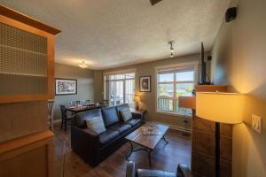 a living room with a couch and a table at Sooke Harbour Resort & Marina in Sooke