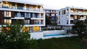 an apartment building with a swimming pool in front of it at Saint George apartments in Varna City