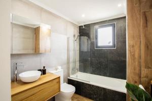 a bathroom with a sink and a toilet and a shower at Pena View Villa in Santa Cruz +15 photos