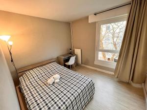 a bedroom with a teddy bear sitting on a bed at Spacieux et Moderne - proche de paris in Evry-Courcouronnes +3 photos