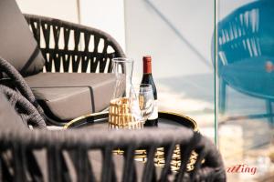 a bottle of wine and a glass on a table at Exclusive Luxury at Mercury Towers in St Julian's