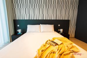 a bed with a blanket and two books on it at Exclusive Luxury at Mercury Towers in St Julian's +21 photos