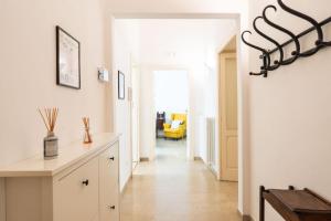 a hallway with white walls and a hallway with a table at Nena House in Bari