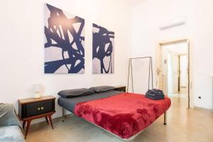 a bedroom with a bed with a red blanket at Nena House in Bari +15 photos