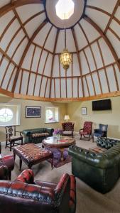 a living room with leather furniture and a dome ceiling at The Courtyard Kilshannig in Fermoy