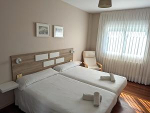 Postel nebo postele na pokoji v ubytování Apartamentos Turísticos Guillermo