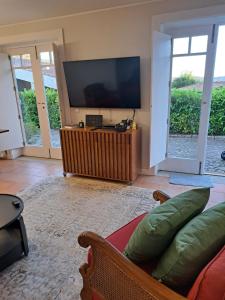 a living room with a television and a couch at Quinta das Mineirinhas in Vila Nova de Cerveira