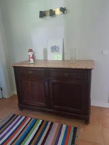 a wooden cabinet with a counter top in a room at Quinta das Mineirinhas in Vila Nova de Cerveira