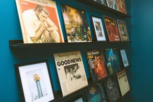 a wall with two shelves filled with movies at Historic Renovated 2BD - Overlooking Downtown in Knoxville