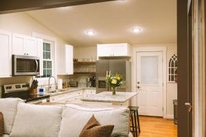 a living room with a couch and a kitchen at Historic Renovated 2BD - Overlooking Downtown in Knoxville