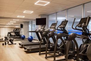 a gym with treadmills and elliptical machines at Sonder Rideau in Ottawa