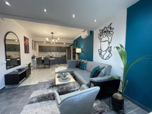 a living room with a couch and a table at Luxury Cityview Apartment with Garden in Serres