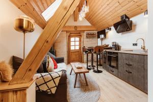 a kitchen and living room in a log cabin at Pension Goldbachmühle in Blankenburg