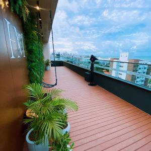a balcony with two plants on a building at Hotel Mana&iacute;ra in Jo&atilde;o Pessoa