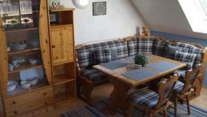 a living room with a couch and a table at Ferienwohnung Kerstin in Strackholt Ostfriesland- Urlaub in Großefehn  +25 photos