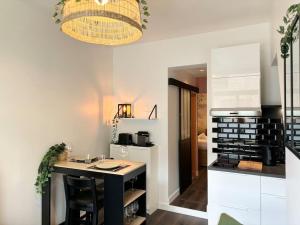 a kitchen with a island in the middle of a room at Vieux-Lille - Deux pièces de charme in Lille
