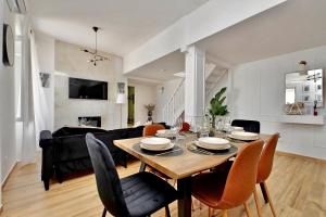 a dining room and living room with a table and chairs at Domus Traiano - Port Apartment in Civitavecchia