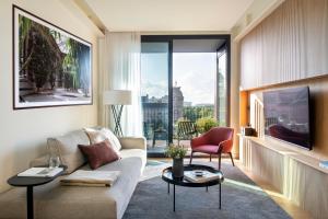 a living room with a couch and two tables at Archie Living in Barcelona